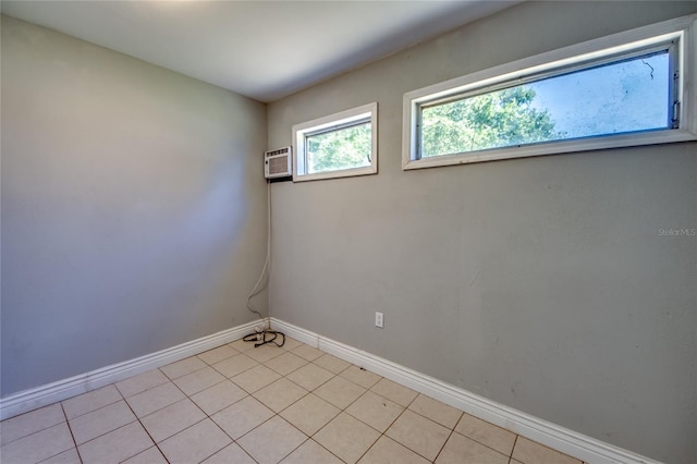 tiled spare room featuring a wall mounted AC