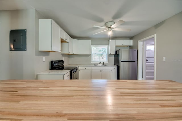 kitchen with stainless steel fridge, black range with electric cooktop, electric panel, and white cabinetry