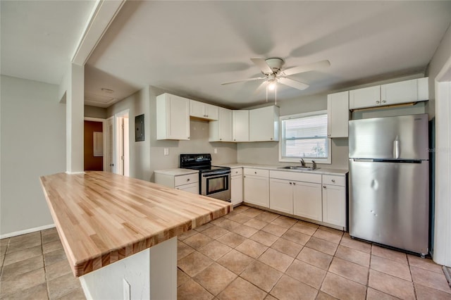 kitchen featuring white cabinets, electric range, stainless steel refrigerator, and sink