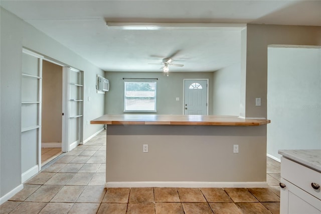 kitchen featuring light tile patterned floors, white cabinetry, and ceiling fan