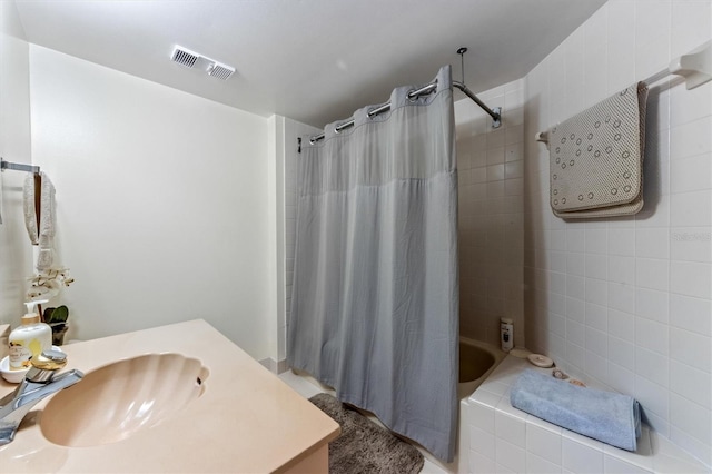 bathroom featuring vanity and shower / bathtub combination with curtain