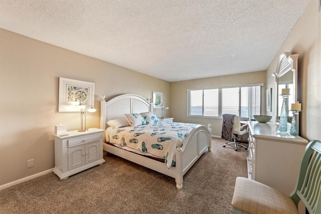 bedroom featuring carpet floors and a textured ceiling