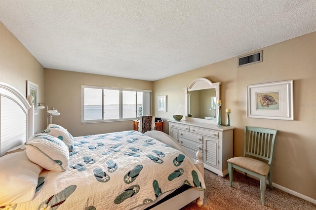 carpeted bedroom featuring a textured ceiling