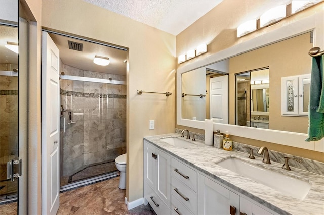 bathroom with a textured ceiling, toilet, and an enclosed shower