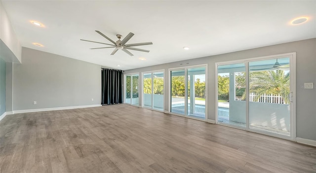 unfurnished room with light wood-type flooring and ceiling fan