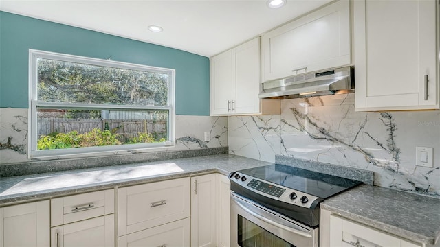 kitchen with backsplash, white cabinetry, and stainless steel range with electric cooktop