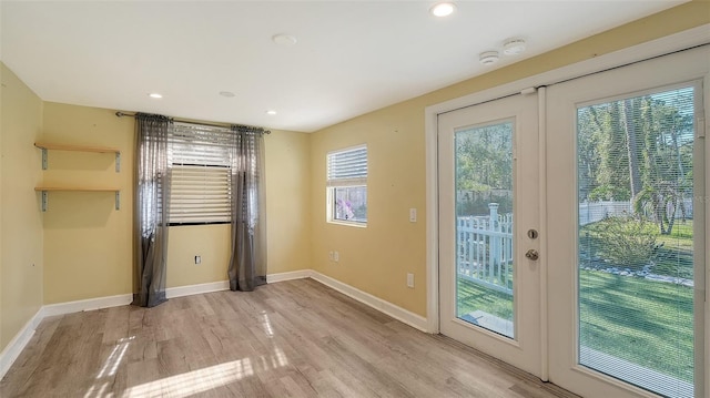 doorway to outside featuring french doors and light hardwood / wood-style floors