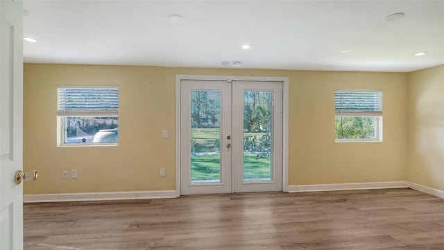 entryway featuring french doors, a healthy amount of sunlight, and light wood-type flooring