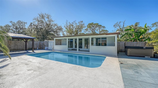 view of swimming pool with a gazebo, a patio, and a hot tub