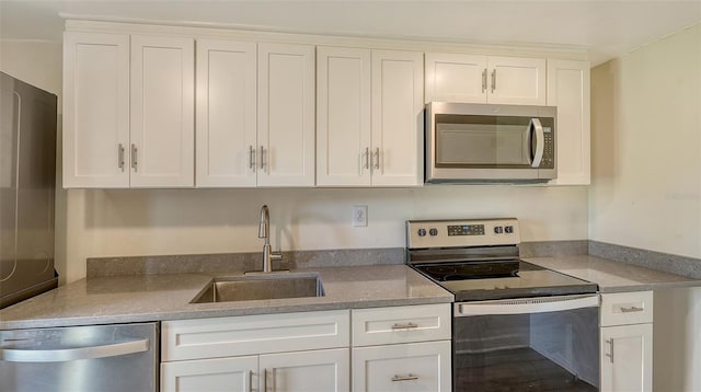 kitchen with white cabinetry, sink, and stainless steel appliances