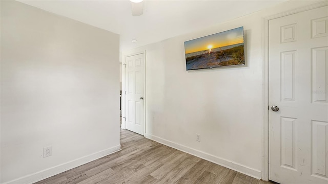 empty room featuring ceiling fan and light hardwood / wood-style flooring