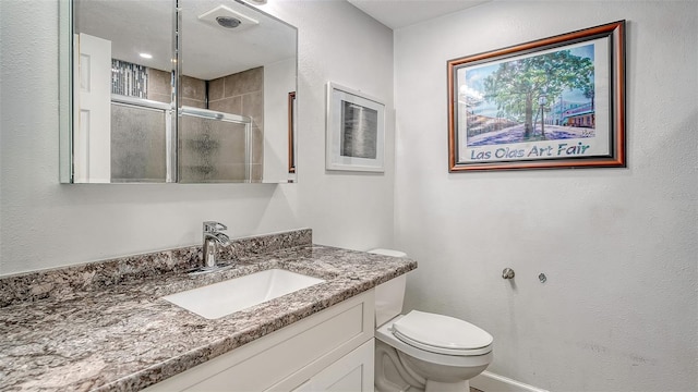 bathroom with vanity, toilet, and walk in shower