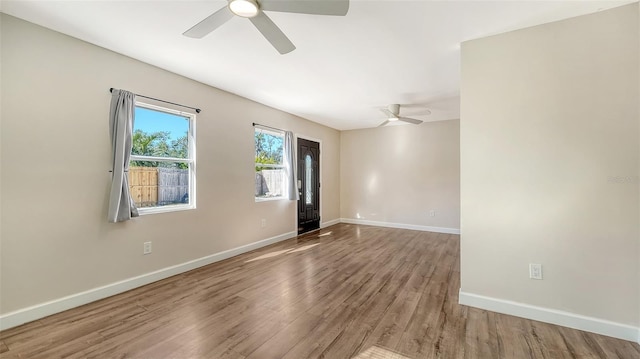 unfurnished room with hardwood / wood-style flooring and ceiling fan