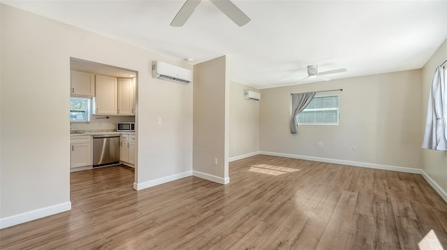 unfurnished living room with a wall mounted AC, ceiling fan, and light hardwood / wood-style flooring