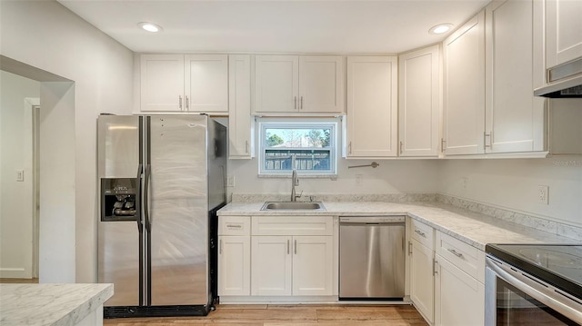 kitchen with white cabinets, sink, and appliances with stainless steel finishes