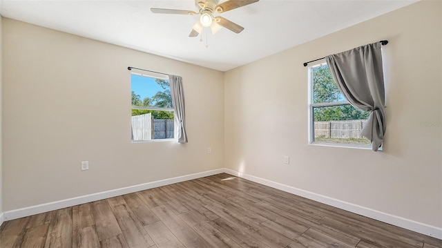 spare room featuring ceiling fan and hardwood / wood-style flooring