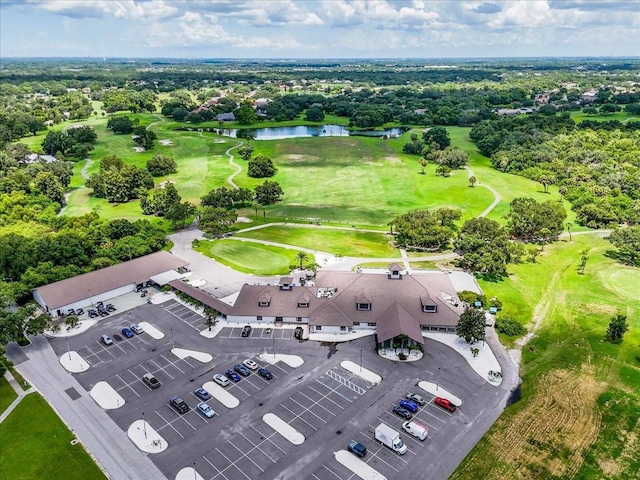 aerial view with golf course view and a water view