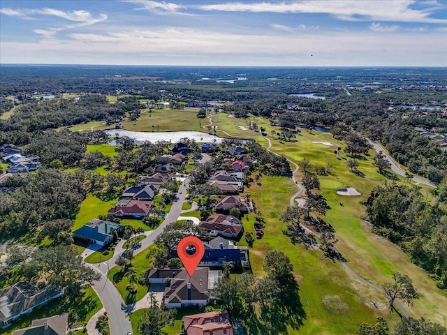 aerial view featuring a residential view, golf course view, and a water view