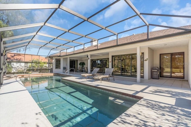 pool featuring glass enclosure and a patio