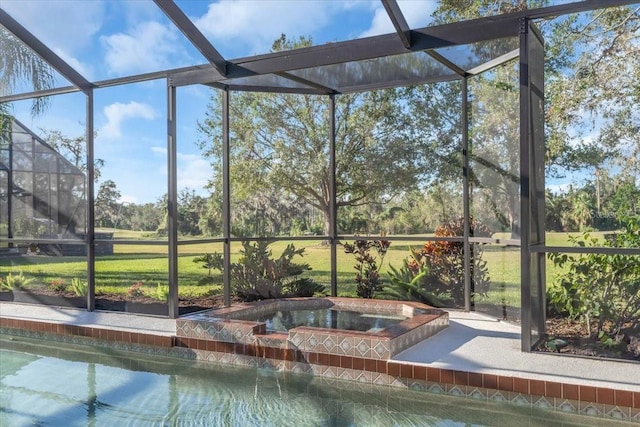 view of pool with a yard, an in ground hot tub, and a lanai