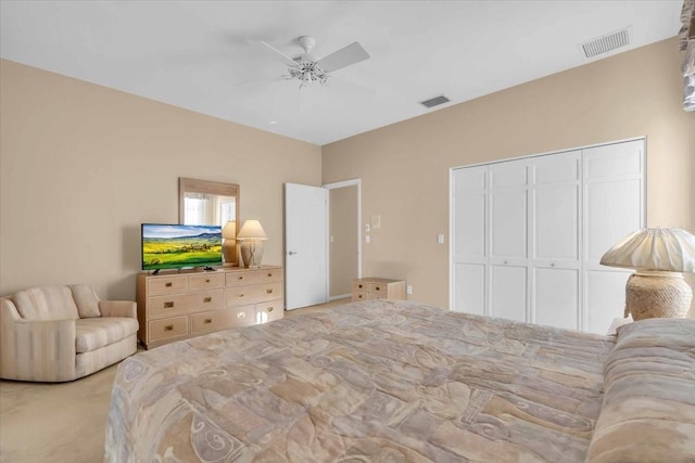 bedroom with carpet floors, visible vents, a closet, and ceiling fan