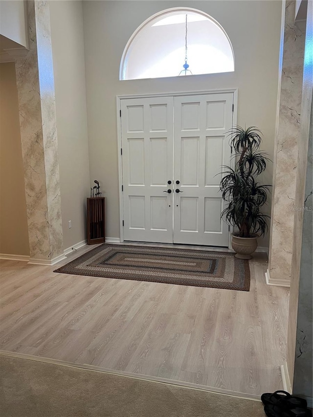 entrance foyer featuring baseboards and wood finished floors