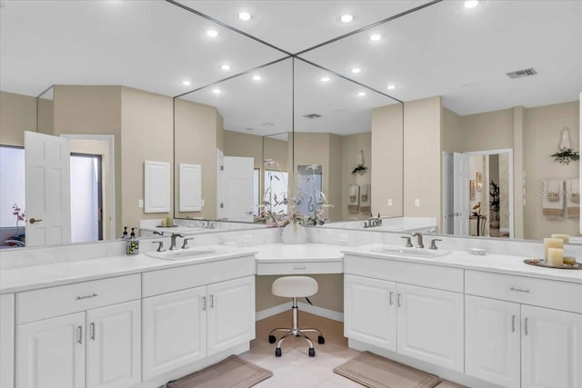 bathroom featuring visible vents, recessed lighting, and vanity