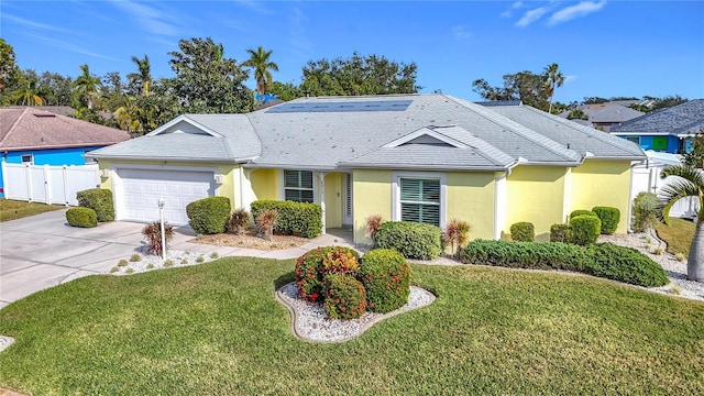 single story home with a garage and a front lawn