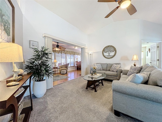 living room with carpet flooring, ceiling fan, and lofted ceiling