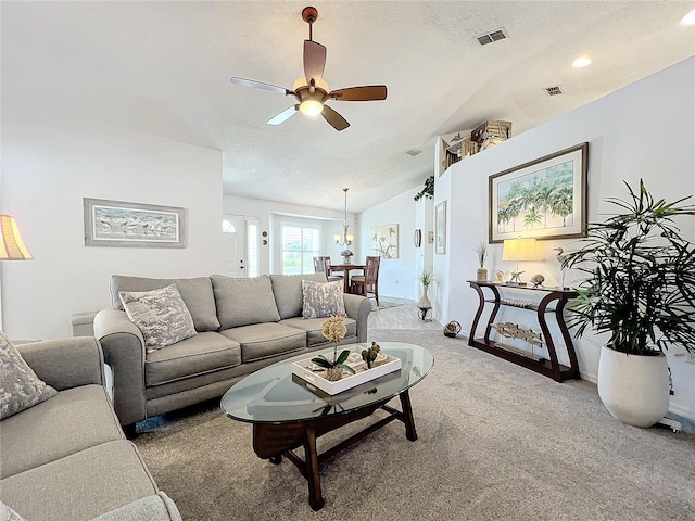 living room featuring carpet flooring, a textured ceiling, and vaulted ceiling