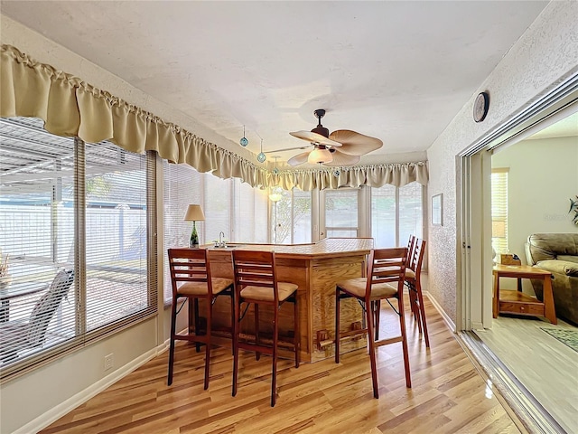 sunroom / solarium featuring ceiling fan