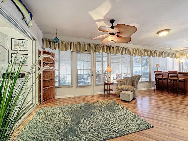 interior space with hardwood / wood-style flooring and ceiling fan