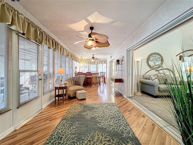 sunroom featuring ceiling fan