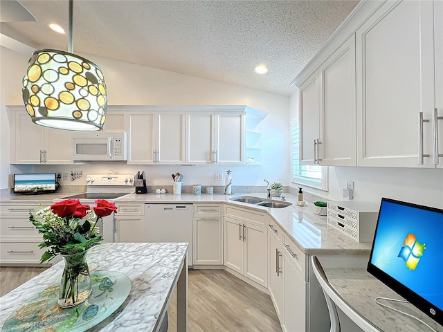 kitchen with sink, light hardwood / wood-style flooring, vaulted ceiling, white appliances, and white cabinets