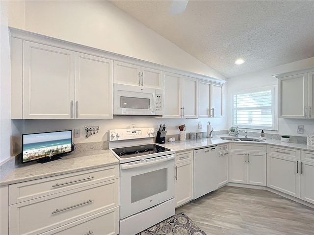 kitchen featuring white cabinetry, sink, vaulted ceiling, a textured ceiling, and white appliances