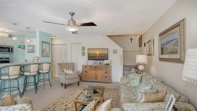 carpeted living room featuring ceiling fan