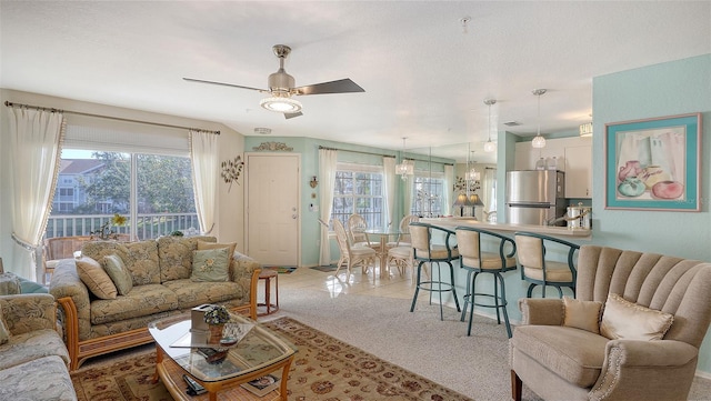 carpeted living room featuring ceiling fan