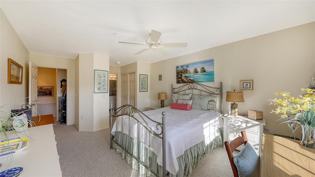 bedroom featuring ceiling fan, light colored carpet, and a closet