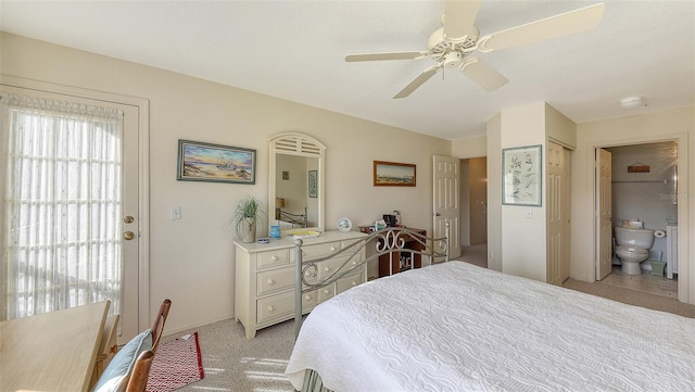 carpeted bedroom featuring ceiling fan and ensuite bathroom