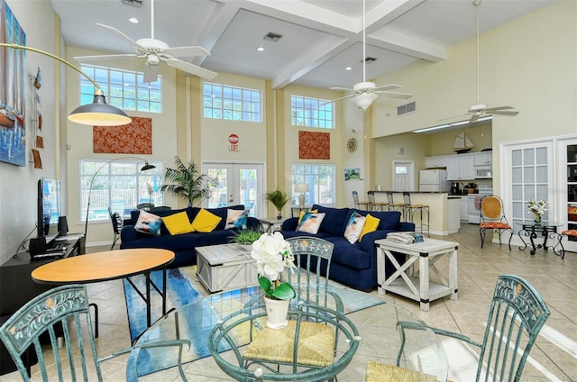 living room with beam ceiling, french doors, a high ceiling, and light tile patterned flooring