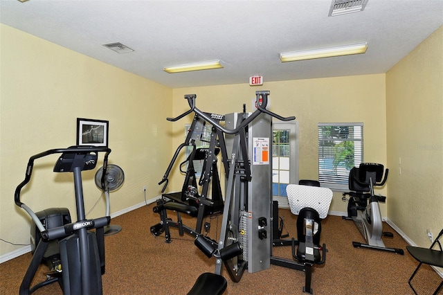 workout area featuring a textured ceiling