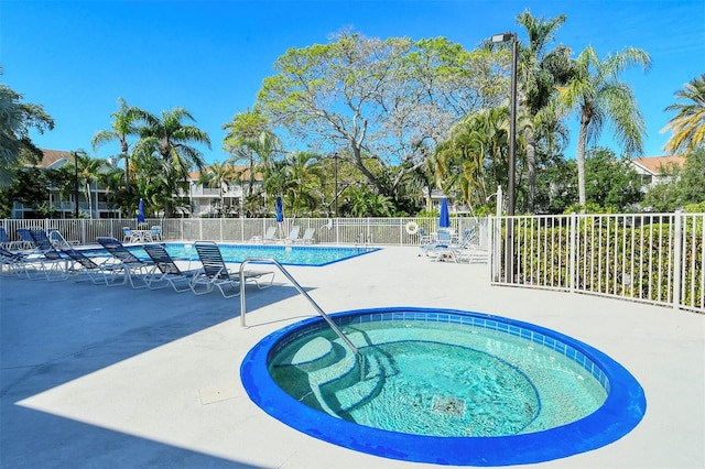 view of pool featuring a patio area and a community hot tub