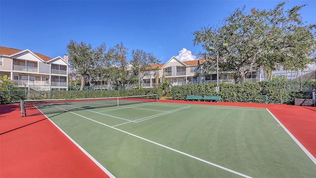 view of tennis court featuring basketball hoop