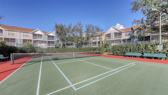 view of tennis court with basketball hoop