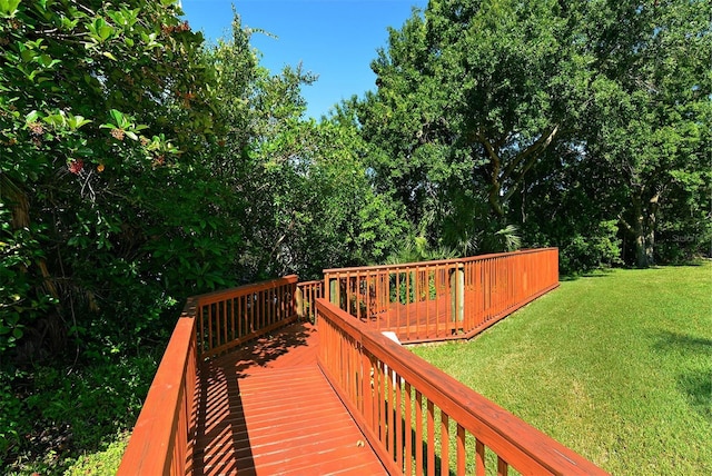 wooden terrace featuring a yard