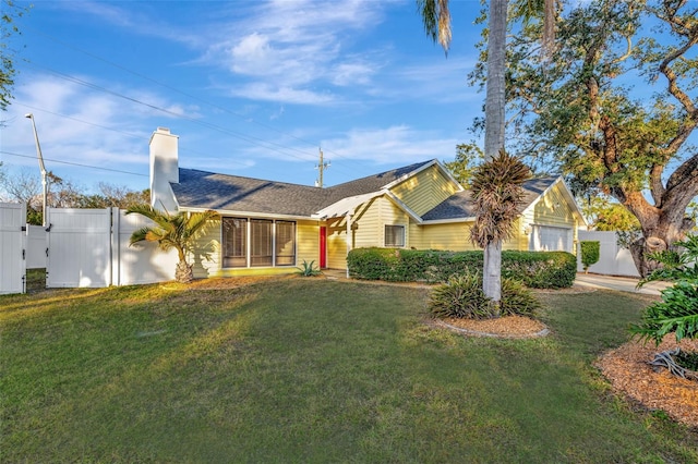 ranch-style house with a garage and a front lawn