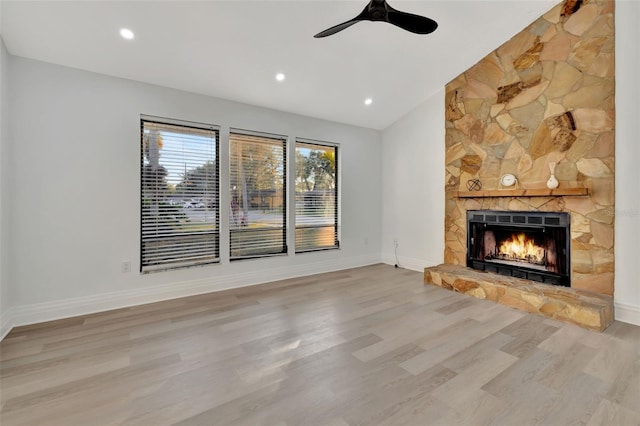 unfurnished living room featuring a fireplace, hardwood / wood-style flooring, ceiling fan, and lofted ceiling