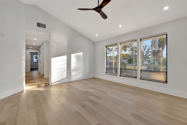 unfurnished living room featuring ceiling fan, vaulted ceiling, and light hardwood / wood-style flooring