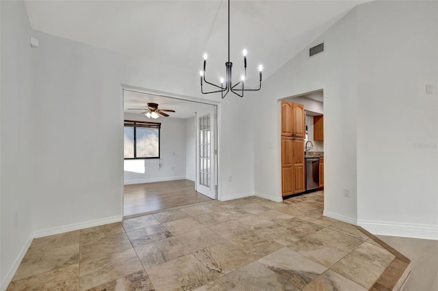 unfurnished dining area with ceiling fan with notable chandelier and lofted ceiling