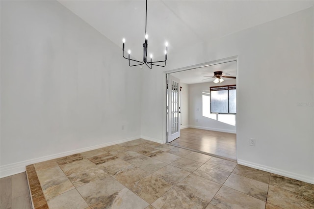 unfurnished dining area with ceiling fan with notable chandelier and vaulted ceiling